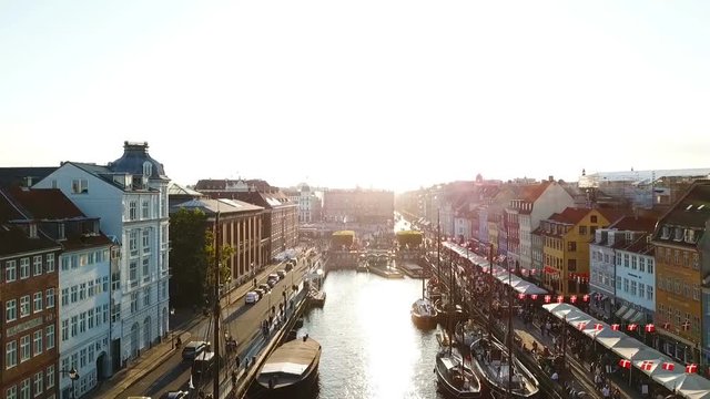 Backlight sunset footage from Copenhagen, Denmark. Nyhavn New Harbour canal and entertainment district. Aerial Video footage view from the top. forward movement. Sunset golden time light.