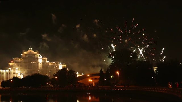 pyrotechnical show with fireworks in night sky on waterfront in minsk 
