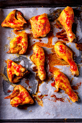 Rustic backed chicken wings,legs on baking tray