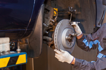 The man is repairing the disc brake