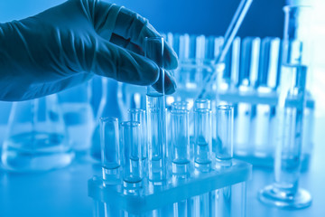 Scientist holding test tube with liquid in laboratory