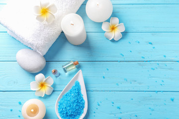 Plakat Beautiful spa composition with sea salt and burning candles on color wooden background