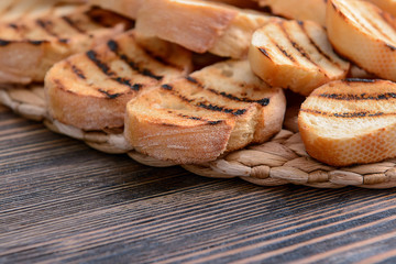 Tasty toasted bread on wooden table