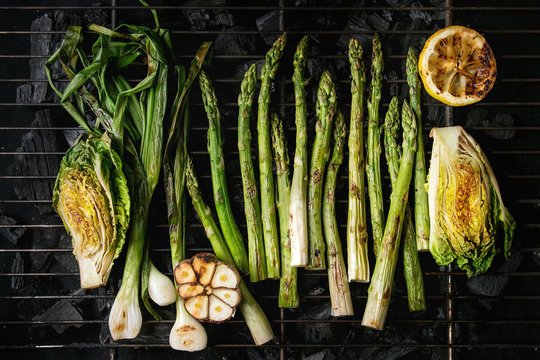 Grilled Vegetables Green Asparagus, Garlic, Lemon, Spring Onion, Salad On Bbq Grill Rack Over Charcoal. Top View, Space.