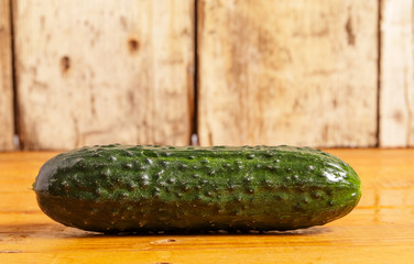 Cucumber is on a wooden stand.