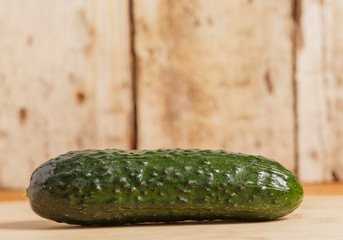 Cucumber is on a wooden stand.