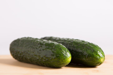 Cucumbers on a wooden stand.