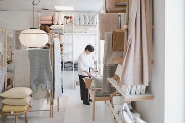 Woman arranging merchandise in store