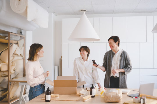 Businesswomen packing products in workshop