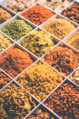 Indian Tea-time snacks like sev, chivda, farsan, mixture, boondi, bakarwadi etc served in white wooden box with cells. selective focus