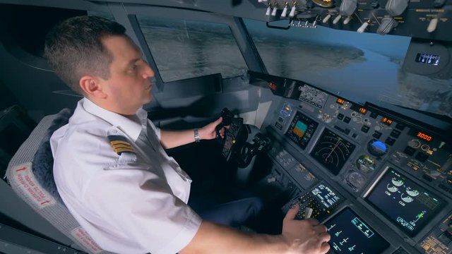 Demonstration flight is being performed by a male instructor in a flight simulator