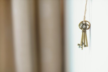 Fototapeta na wymiar Vintage keys hanging on wall, key concept