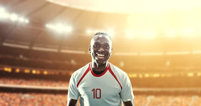 Happy soccer player on a football stadium