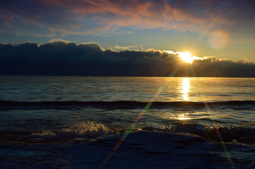 Sunset with snow and ice on lake huron