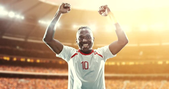 Happy soccer player on a football stadium