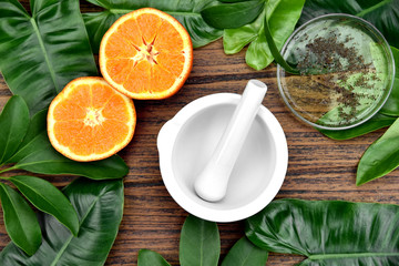 Natural organic medicine and healthcare, Alternative plant medicine, Mortar and orange slices vitamin-c extract.