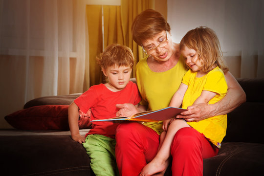 Grandmother reading a tale to her grandchildren. Family Reading Leisure  
