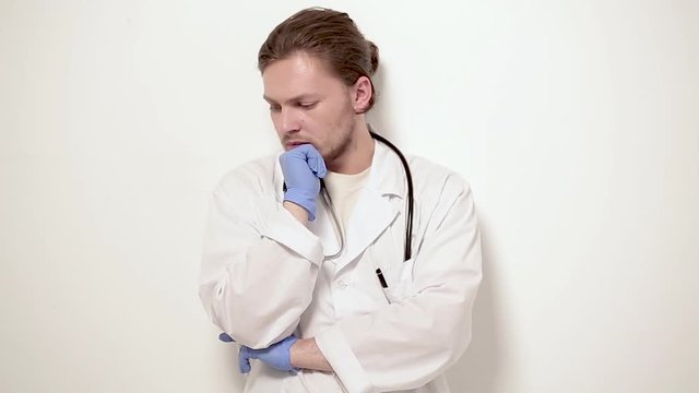 Young vet touching cheen and looking aside. Had difficult examining. Veterinary concept.