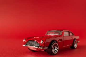 Toy car in red background isolate