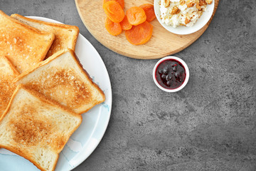 Flat lay composition with toasted bread, jam and cream cheese on grey background