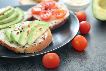 Toasted bread with avocado and cherry tomatoes on plate