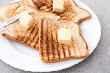 Toasted bread with butter on plate