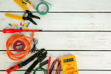 Flat lay composition with electrical tools on wooden background