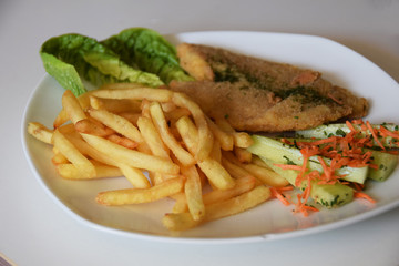 fries and a salad of fresh cucumber and grated carrot fried fish