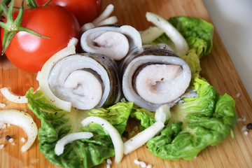 raw fish fillet with tomatoes, spices and onions