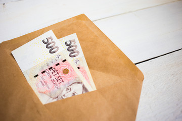 close up bundle of money Crown banknotes in the envelope, business, finance, saving, banking concept
