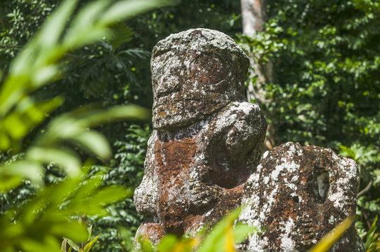 historic stone statues, so called Tikis, created by native inhabitants of Hiva Oa,  Marquesas Islands, French Polynesia
