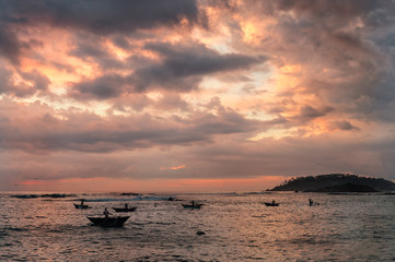 Traditional fishing boats at sunset at tropical coast of Sri Lanka