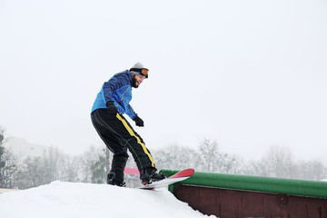 Male snowboarder at winter resort