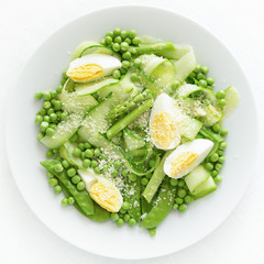 salad of cucumber, asparagus, peas and pea pods with egg and cheese dressed with oil and vinegar