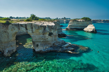 Scenic view of the "faraglioni" rocky cliffs of St. Andrew on the coast of Salento, in Apulia Italy.