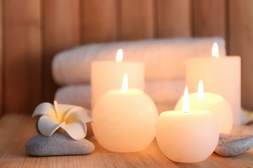 Fototapeta na wymiar Beautiful spa set with burning candles on wooden background