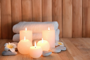 Fototapeta na wymiar Beautiful spa set with burning candles on wooden background