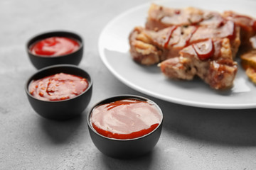 Delicious barbecue sauces in bowls on table