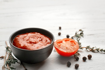 Delicious barbecue sauce in bowl on table