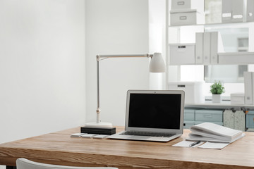Stylish workplace with laptop on table