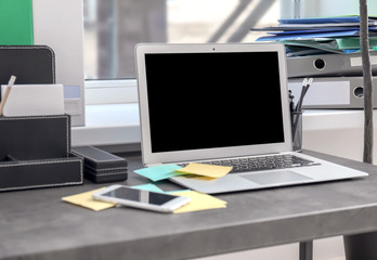 Stylish workplace with laptop on table