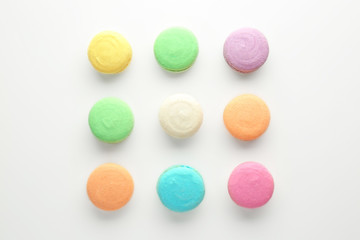 Fototapeta na wymiar Tasty colorful macarons on white background, flat lay