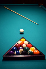 Colored balls of the American pool are collected in a triangle on a billiard table
