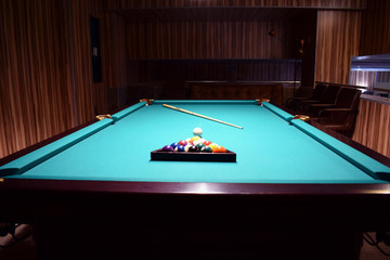 Colored balls of the American pool are collected in a triangle on a billiard table