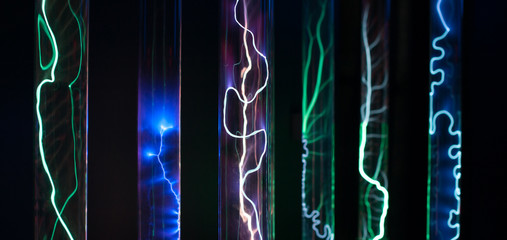 Plenty of plasma glass flasks of cylinders filled with intertidal gases, with a high voltage source