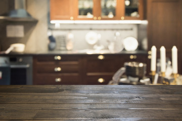 Blurred abstract background. Modern dark kitchen interior with tabletop for background and space for you.