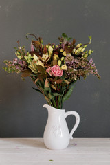 A bouquet of flowers in a jug