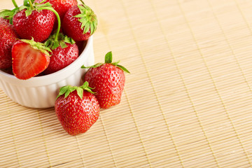 Fresh red strawberries on a wooden background. Summer berries. The concept of healthy eating.