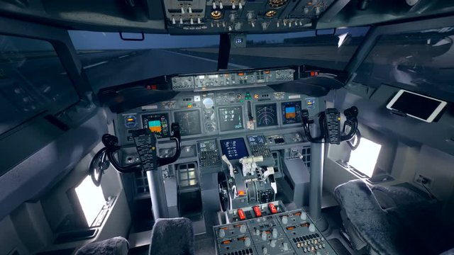Detailed footage of a cockpit of a plane which is standing on a take-off runway