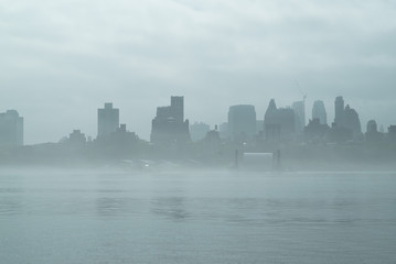 Rainy Manhattan, business district of New York City, heavy fog.